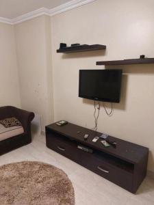 a living room with a tv and a coffee table at Full sky apartment in Irbid +17 photos