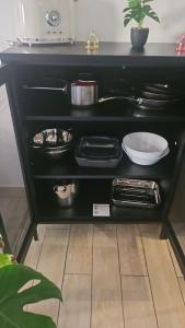 a black table with plates and dishes on it at Maison Soleil - Elne in Elne +47 photos