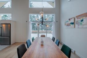 een eetkamer met een houten tafel en stoelen bij Chalet Odin - SPA, PISCINE, SAUNA partagés in Valcartier Station