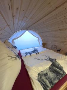 a bed in a small room with a window at Maurerhof's Fässle in Weilheim