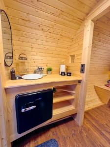a bathroom with a sink in a wooden cabin at Maurerhof's Fässle in Weilheim +15 photos