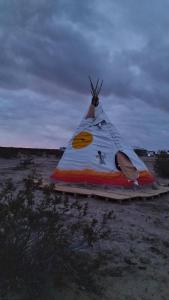 a tent sitting in the middle of a field at Tee Pee at Maringa Serrano in Joshua Tree