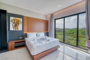 a bedroom with a large bed and a large window at Bhumi Villas 2BR Ricefield View in Canggu in Munggu +38 photos