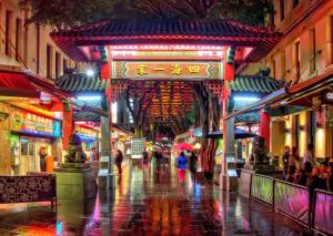 a city street at night with people walking down the street at Darling Harbor living - Sydney 2 beds condo pool in Sydney