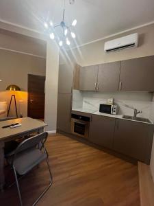 a kitchen with a table and a sink and a counter at Tris Appartements in Poggibonsi +13 photos