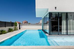 a swimming pool in front of a house at Villa Restart Vrsi-Mulo in Vrsi