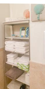 a towel rack with towels on it in a bathroom at Coastal King Beach Flat Convenient to Everything! in Hilton Head Island