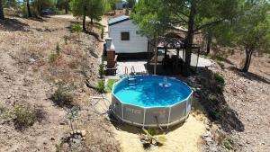 a hot tub in a yard next to a house at Into the wild in Alcoutim