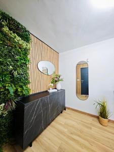 ein Raum mit einer Pflanzenwand und einem Spiegel in der Unterkunft Casa boutique premium con diseño de autor y confort in Hinojosa del Duque