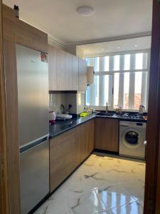 a kitchen with a refrigerator and a washing machine at Riad Ajdir Al Hoceima in Andalouciene