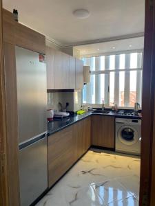 a kitchen with a refrigerator and a dishwasher at Riad Ajdir Al Hoceima in Andalouciene +7 photos