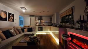 a living room with a couch and a fire place at The Bridge in Dartford