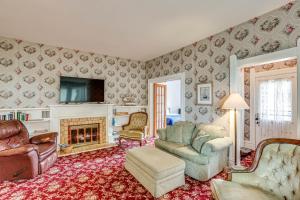 a living room with a couch and a fireplace at Walk to Lake Michigan and Dtwn Coastal Grand in Ludington