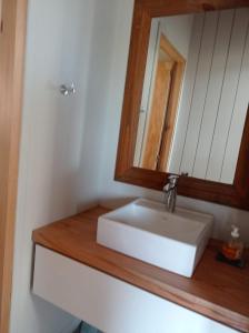 a bathroom with a white sink and a mirror at Cabañas Altas Vistas in Sierra de la Ventana +14 photos