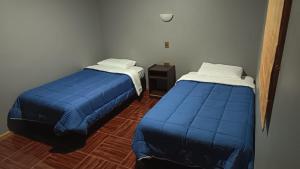 Cama o camas de una habitación en Lodge Atacama Hostal