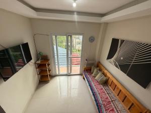 a living room with a large sliding glass door at Sojourn 2600 in Baguio