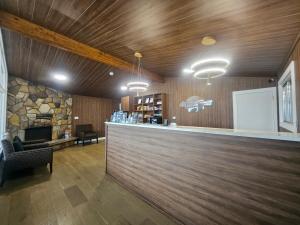a bar in a restaurant with a stone fireplace at Howard Johnson by Wyndham Hinton in Hinton