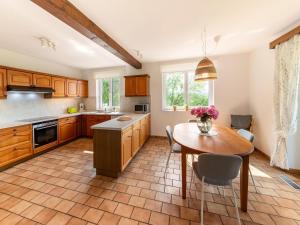a kitchen with a table and a dining room at Charming cottage in heart of the Ardennes in Lierneux