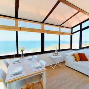 a living room with a table and a couch at Foz do Arelho Sunset Sea Views Apartment in Foz do Arelho
