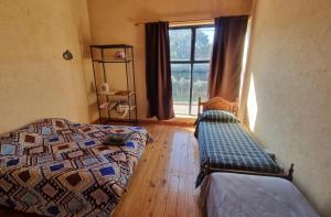 a bedroom with two beds and a window at MotoHouse-Tl in Trenque Lauquen