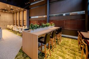 a conference room with tables and chairs and plants at Richmond Hotel Kagoshima Tenmonkan in Kagoshima