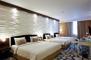 Krevet ili kreveti u jedinici u okviru objekta Hotel New Saphir Yogyakarta