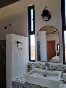 a bathroom with a sink and a mirror at Nest Aprt in San Carlos
