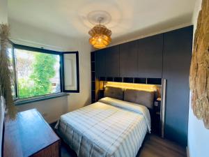 a bedroom with a bed and a window at Il canto della pineta in Principina a Mare