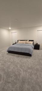 a bedroom with a bed in a white room at DIA Easy Rest and Stay in Commerce City