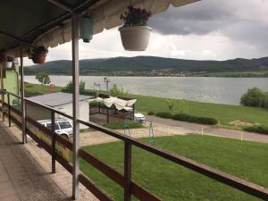a view from the porch of a house overlooking a lake at Turistická ubytovňa Hotel Divin in Divín
