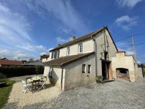 a small house with a table and a patio at Gîte Contemporain Confortable à Louchy-Montfand avec Piscine Partagée - FR-1-489-444 in Louchy-Montfand