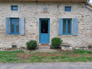 a house with a blue door and two windows at Gîte familial à Chavroches, animaux acceptés - FR-1-489-574 in Chavroches