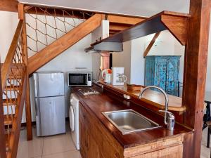 a kitchen with a sink and a refrigerator at Résidence Marina Beach in Noumea