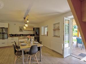 a kitchen and dining room with a table and chairs at Gîte de charme avec spa, terrasse et balcon - Tout confort, au cœur de la nature - FR-1-496-303 in Pouilly-les-Feurs