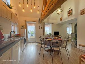 eine Küche und ein Esszimmer mit Tisch und Stühlen in der Unterkunft Charme rustique près de Bagnoles, animaux admis, jardin et WiFi inclus - FR-1-497-222 in La Coulonche + 10 Fotos