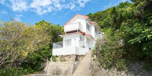 a white house on a hill with stairs in front at Awaji Kusaka Jungle in Awaji