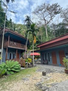 a house with a porch and a balcony on it at BESTUBA COTTAGE at PULAU TUBA, LANGKAWI in Pulau Selang Besar