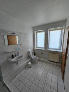 a bathroom with a toilet and a sink at Private room with private bathroom in Rostock