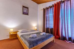 a bedroom with a bed with two pigs on it at Modern 3BR Duplex - Val Thorens Centre, Parking & Panoramic Views in Val Thorens
