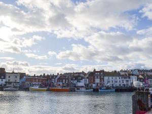 a group of boats are docked in a harbor at Pig Sty Cottage - E1867 in Powerstock +2 photos