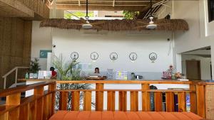 a restaurant with a counter with clocks on the wall at Bohol Coastal View Hotel in Taiwala