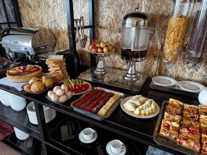 a buffet with different types of food on a table at BarBulak Yurt Lodge in Bar-Bulak