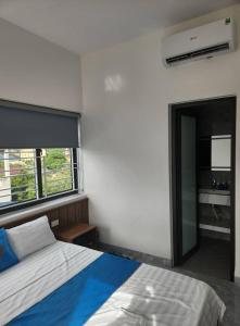 Un dormitorio con una cama y una ventana grande en Lộc Phát Hotel MC by BAY LUXURY, en Mộc Châu