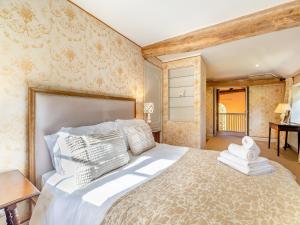 a bedroom with a large bed in a room at Barn House in Aubourn