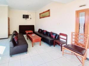 a living room with a couch and a table at RedDoorz near BNS 3 Kota Wisata Batu in Malang