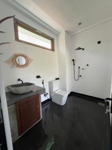 a bathroom with a sink and a toilet at Hakuna Matata Arugambay in Arugam Bay