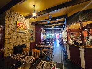 a restaurant with tables and chairs and a bar at Listowel Town A in Listowel
