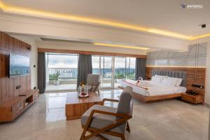 a large bedroom with a bed and a large window at Winterfeel Luxury Resort Kodaikanal in Kodaikānāl