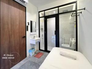 a bathroom with a bed and a sink and a toilet at Room l 4min Walks to Pelangi Plaza in Johor Bahru