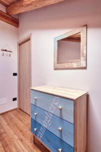 a blue dresser in a room with a mirror at Locanda Del Silenzio Residence in Macra
